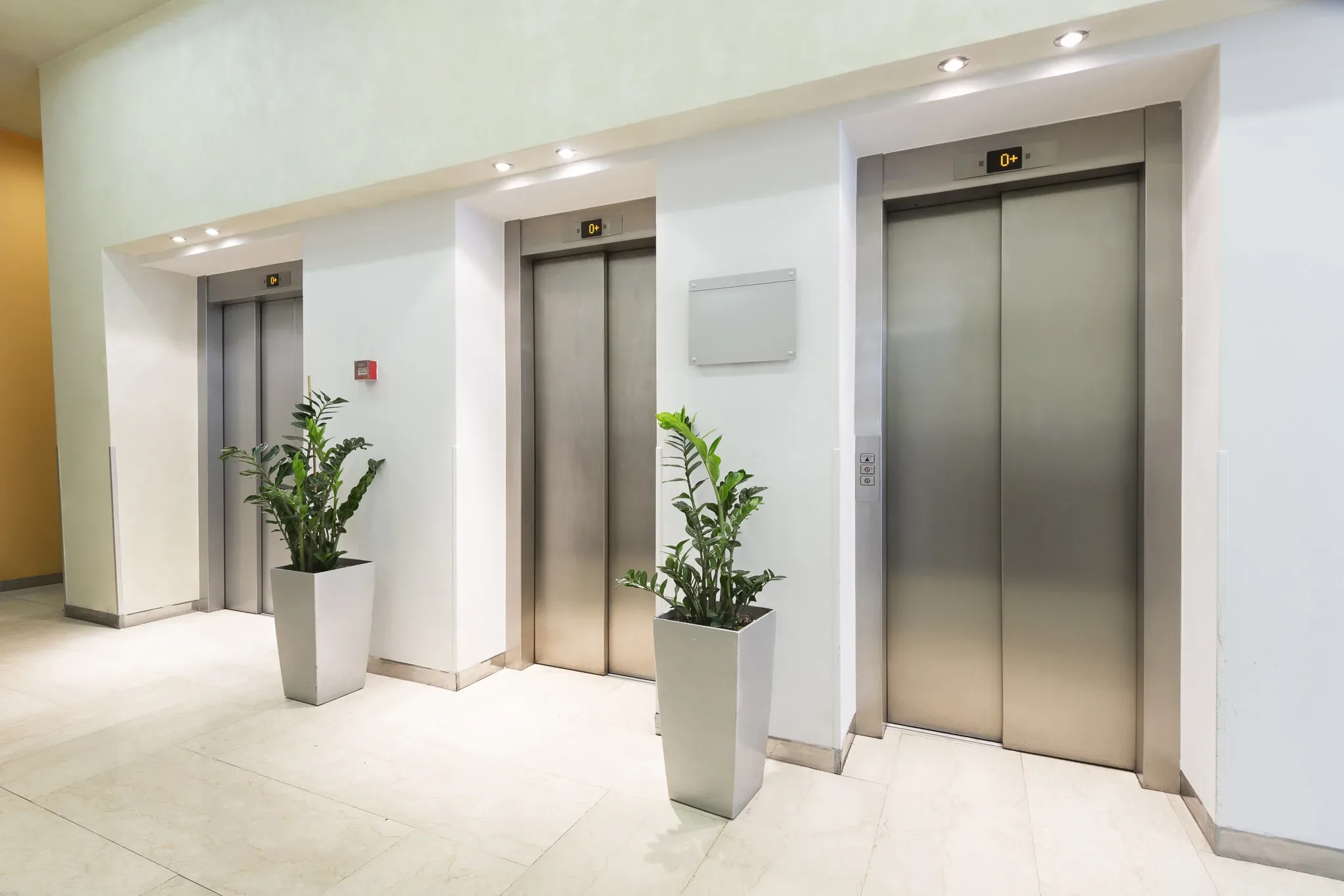 A group of elevators in an office building.